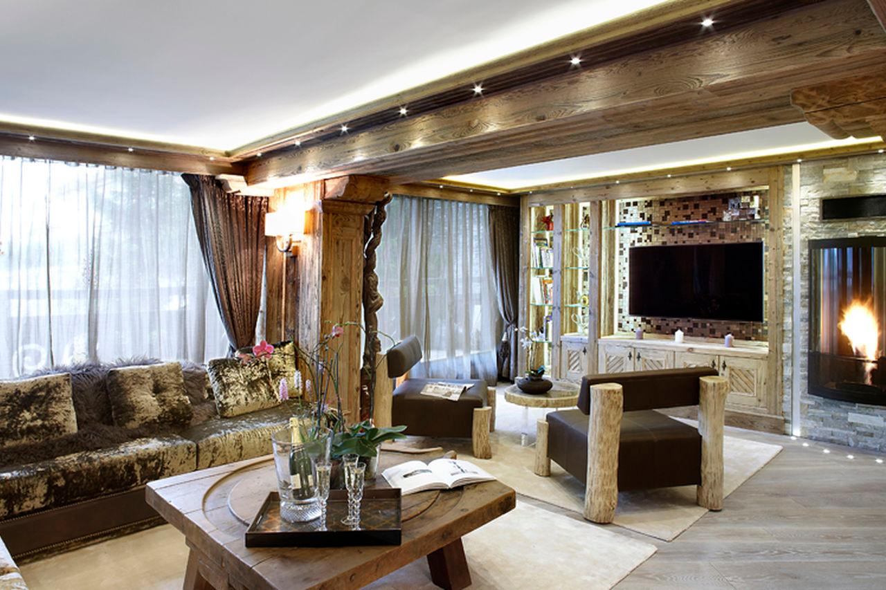Comfortable sofas in front of wood-burning stove in Apartment Albaron in Courchevel 1850