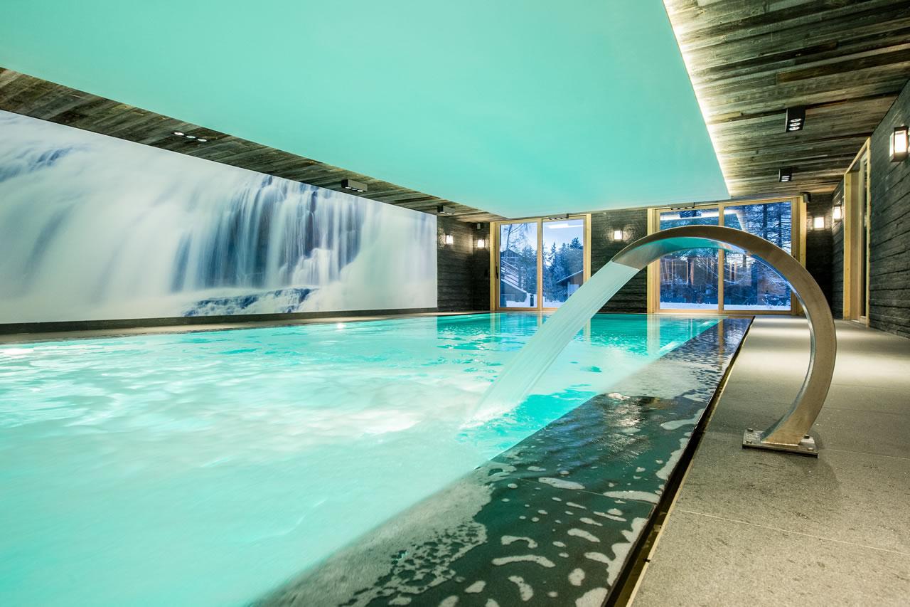 Shared swimming pool with view on the garden in Apartment Aminona in Crans-Montana