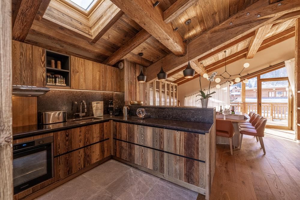 Kitchen and dining area at Chalet Bois des Barmes in Courchevel La Praz