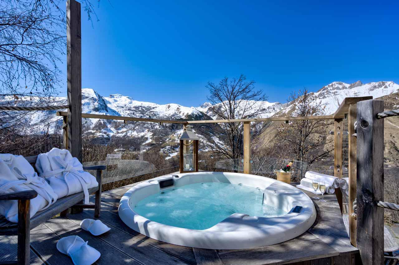 Outdoor hot tub with mountain views at Chalet Coco in St Martin De Belleville