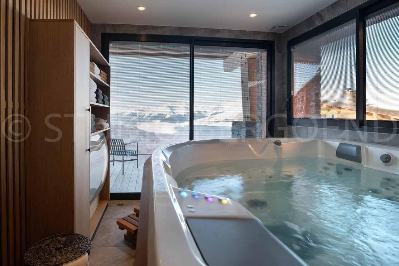 Indoor hot tub overlooking mountain peaks at Eden Mille 8 in Les Arcs
