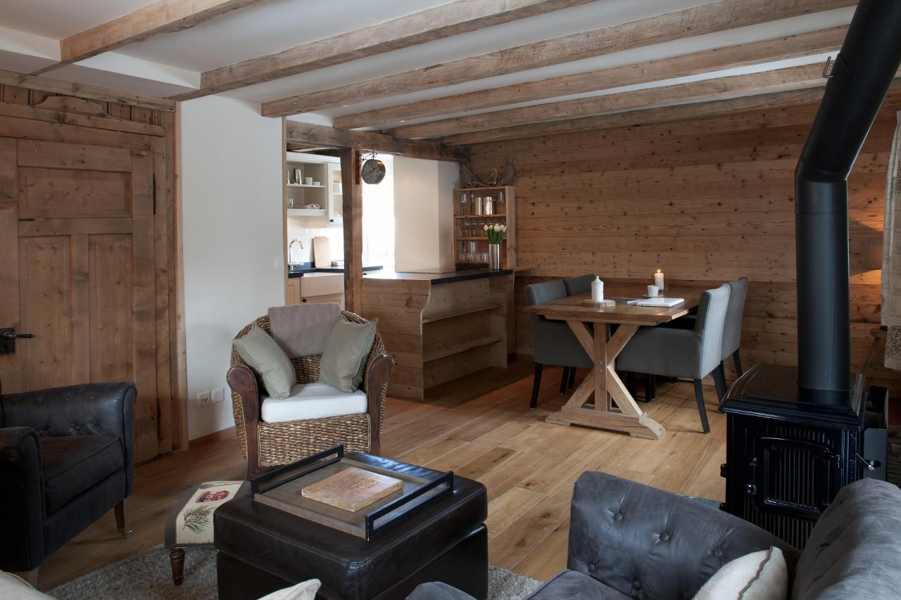 Dining table and kitchen at Silverbirch Chalet in Davos