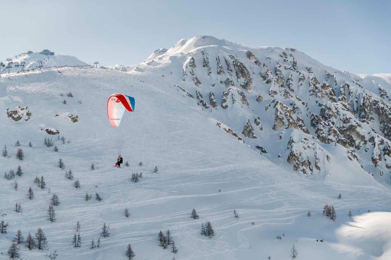 Paragliding over mountains in Tignes